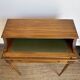 Louis XVI style mahogany telephone table with a green leather top.