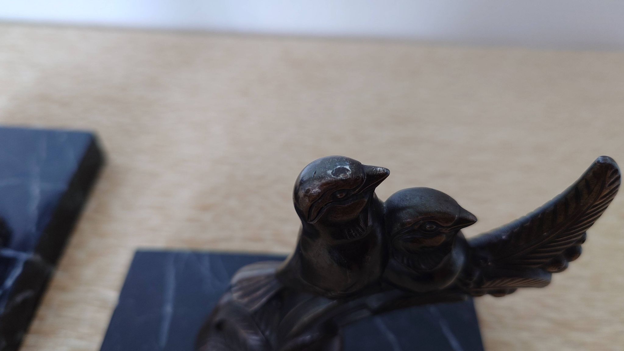 Pair of Art Deco bookends signed Frécourt, patinated metal & black marble