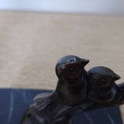 Pair of Art Deco bookends signed Frécourt, patinated metal & black marble