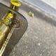 Vintage side table with smoked glass and sculpted golden brass, Hollywood Regency style.