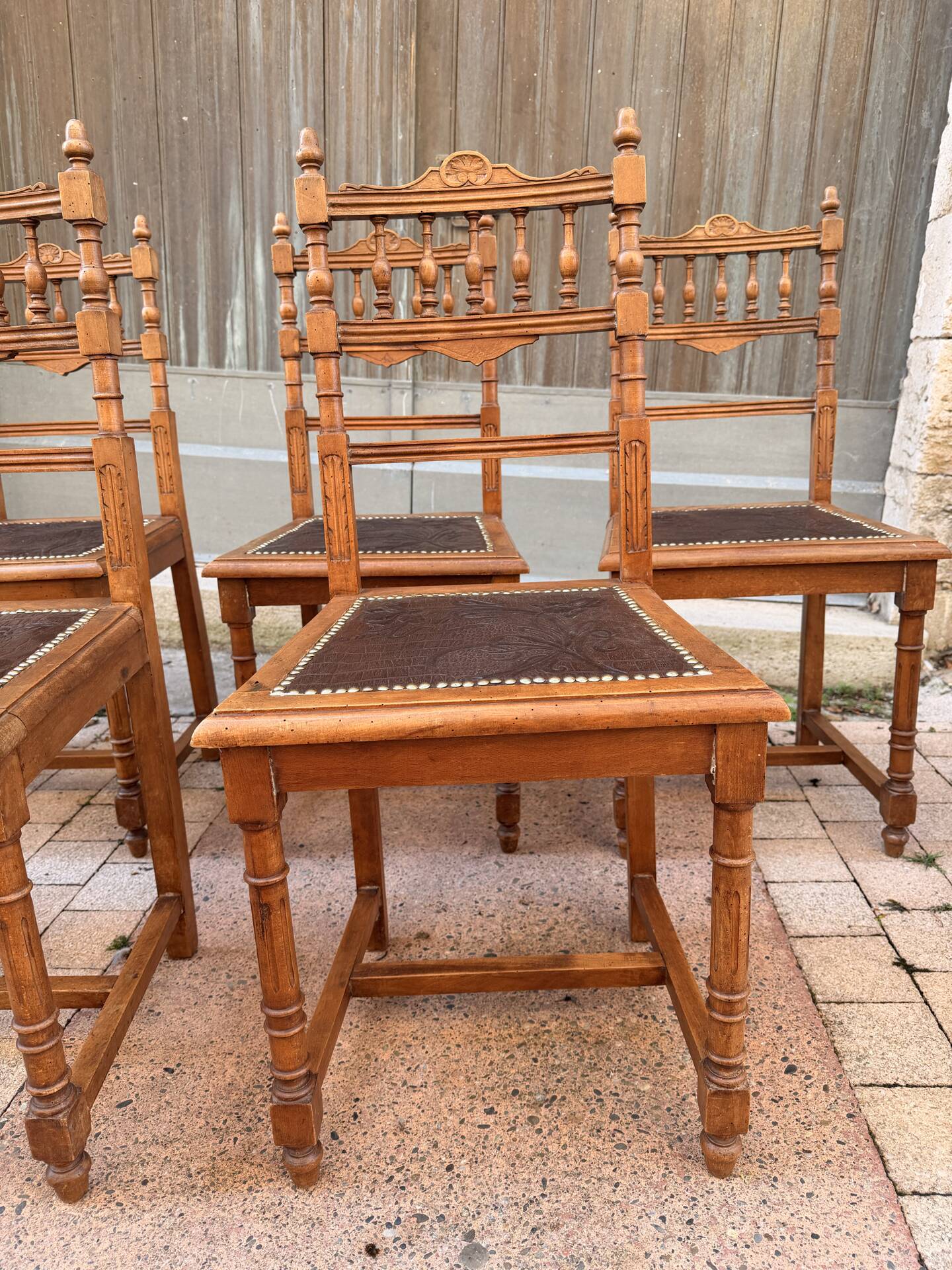Set of 6 antique turned wooden chairs with embossed leather seats.