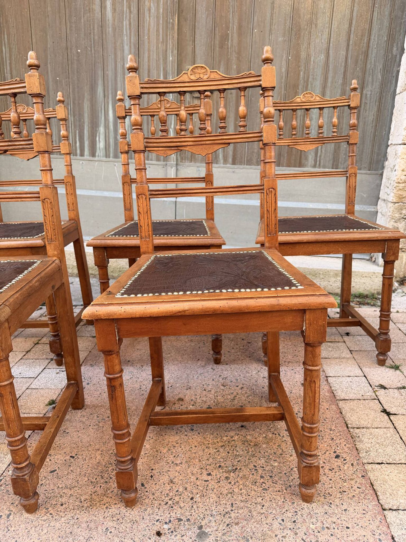 Set of 6 antique turned wooden chairs with embossed leather seats.