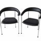 Set of two metal chairs with a brushed finish and black leather.