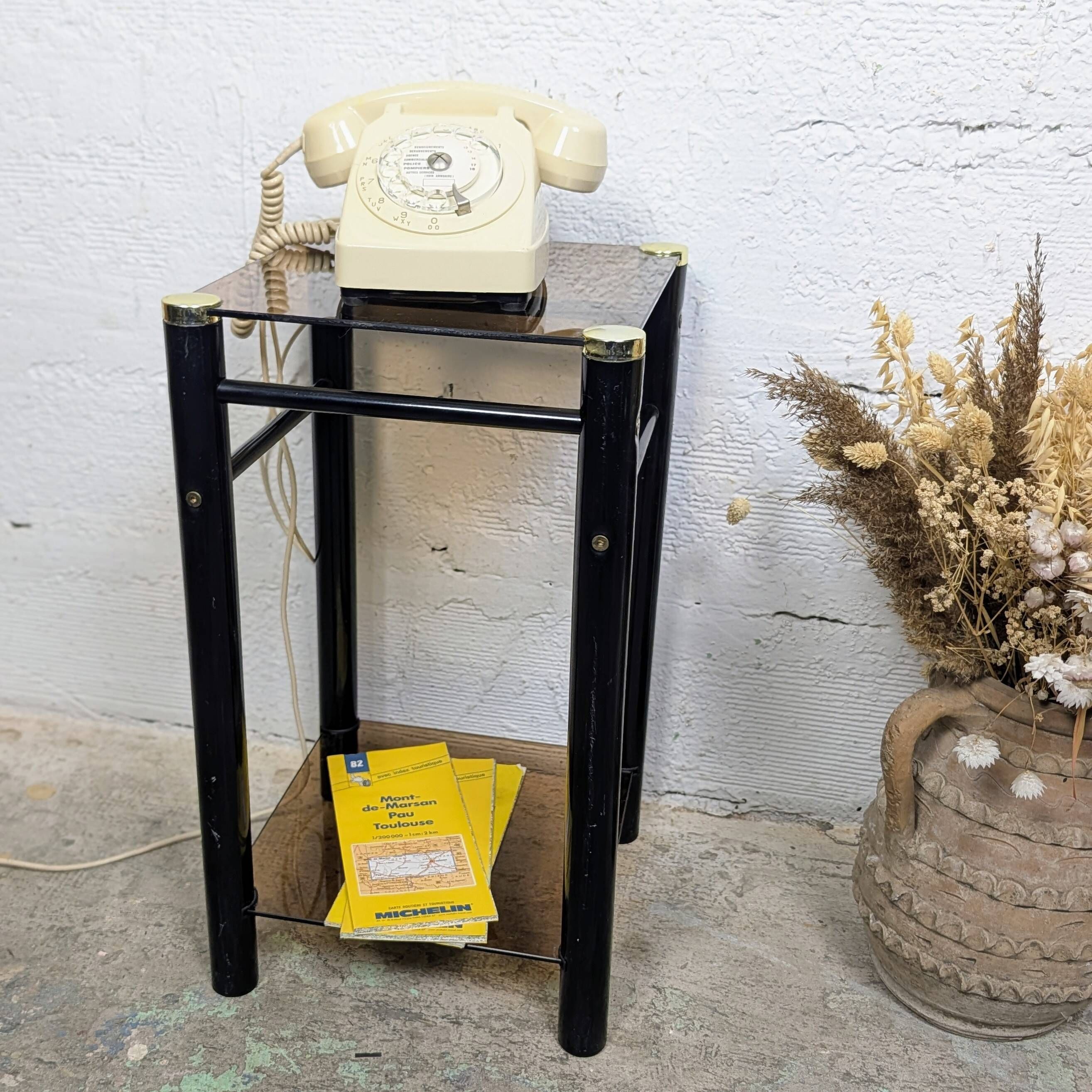 Vintage side table with two smoked glass tops and black metal.