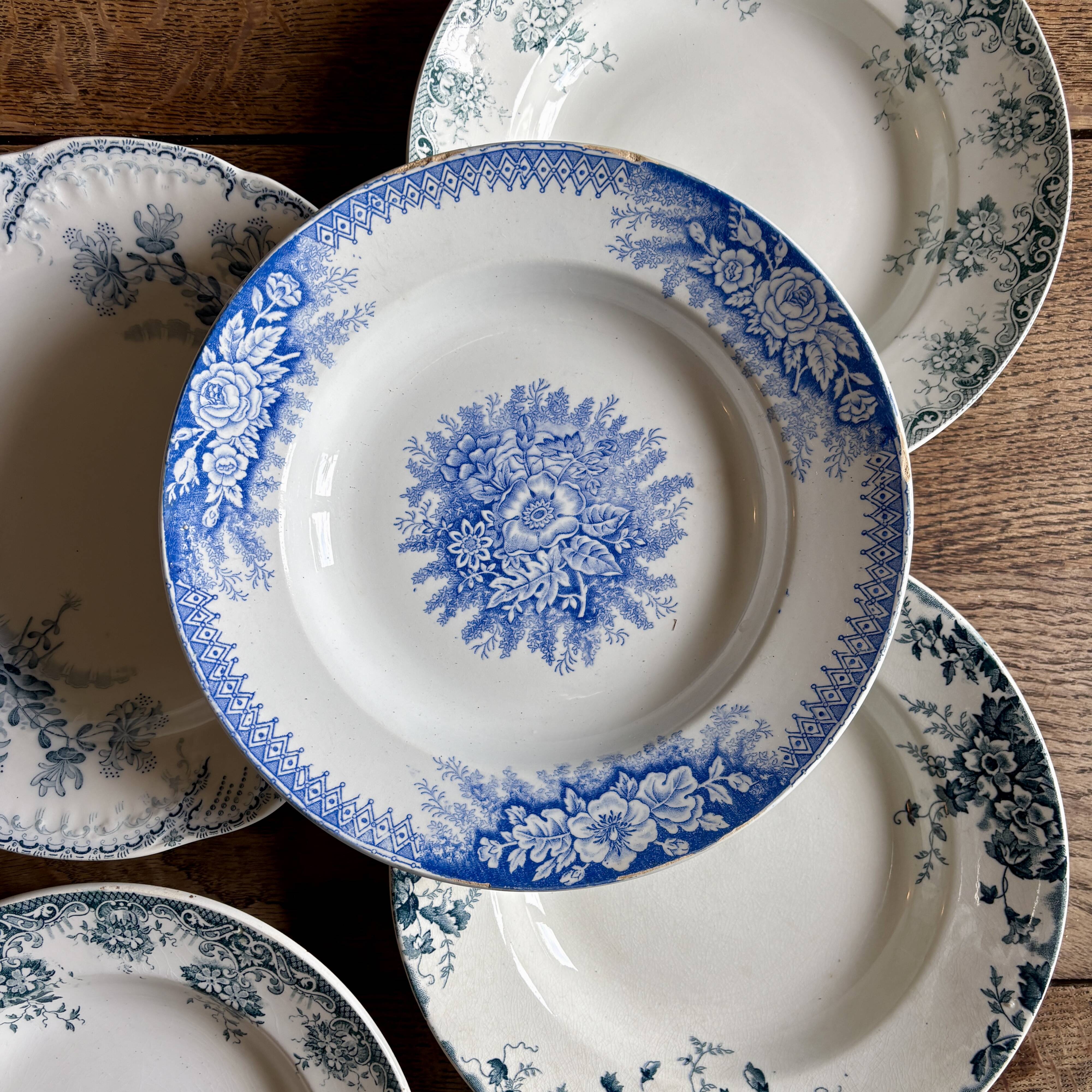 Set of 8 mismatched antique ironstone deep plates.