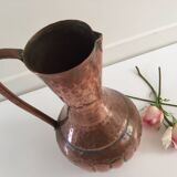 Pitcher-shaped vase in hammered copper