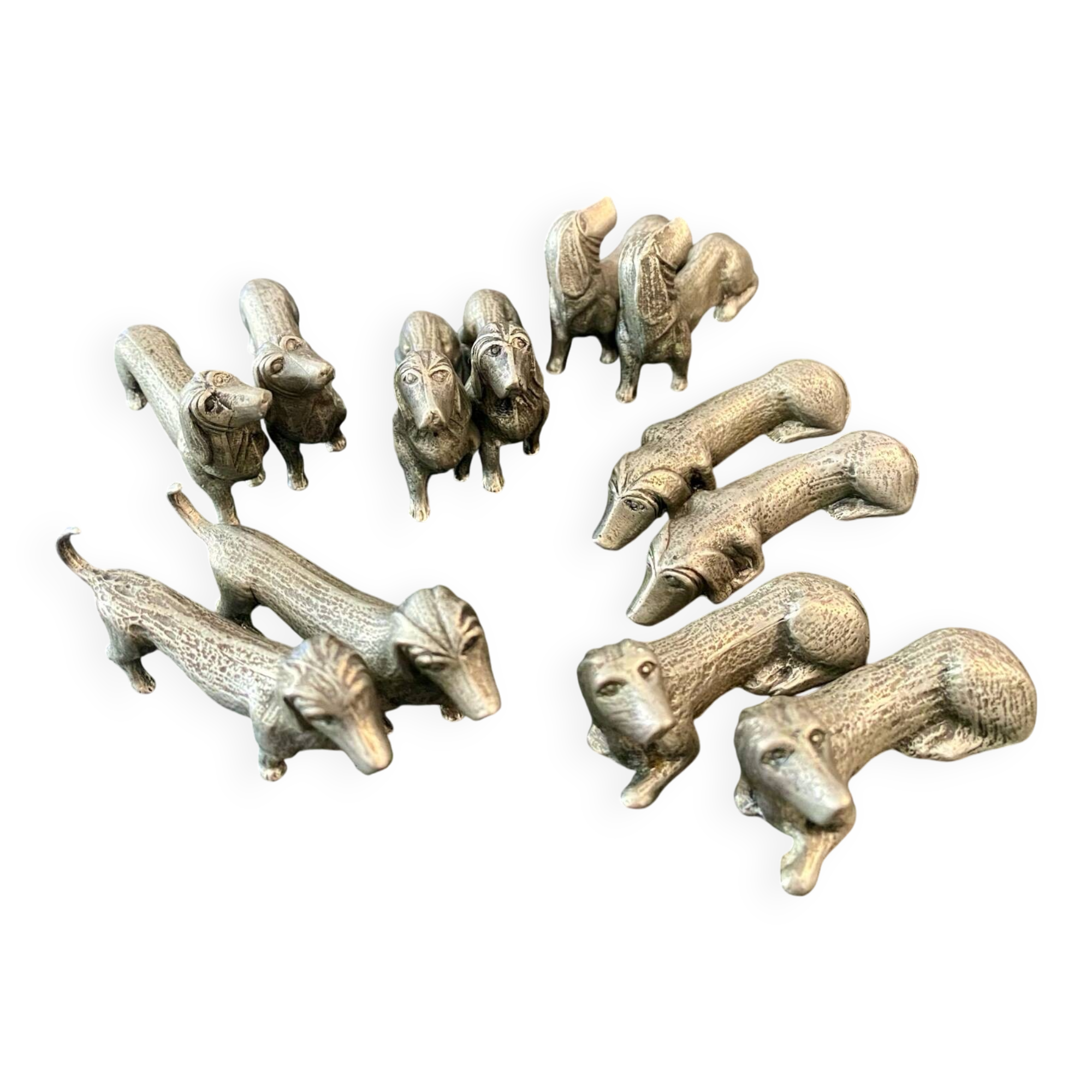 12 old dog-shaped Etains du Manoir knife holders