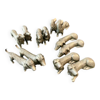 12 old dog-shaped Etains du Manoir knife holders