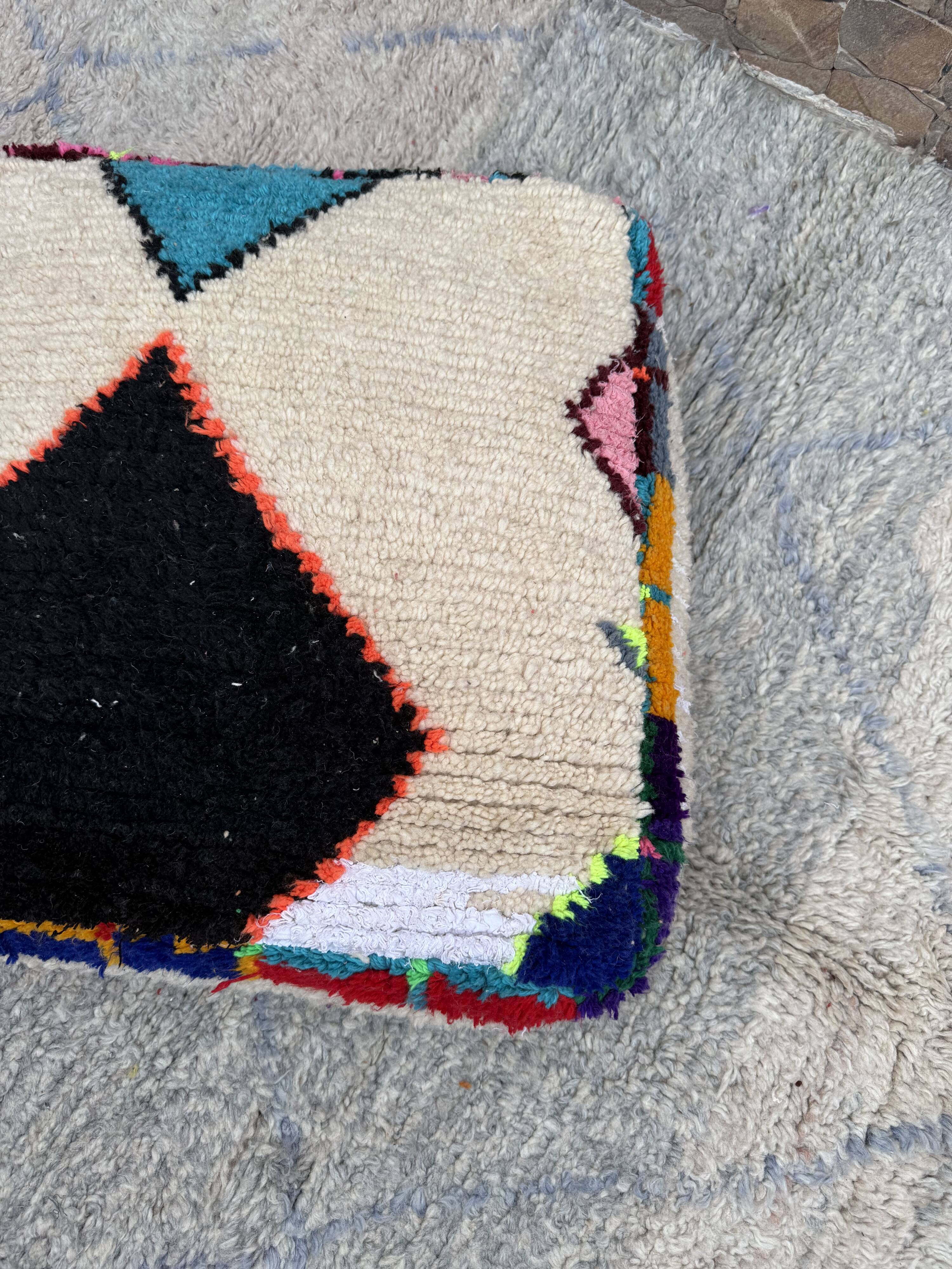 Berber floor pouf: Handwoven Moroccan wool cushion.