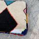 Berber floor pouf: Handwoven Moroccan wool cushion.