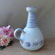 Vintage blue ceramic jug with hand-painted floral decoration.