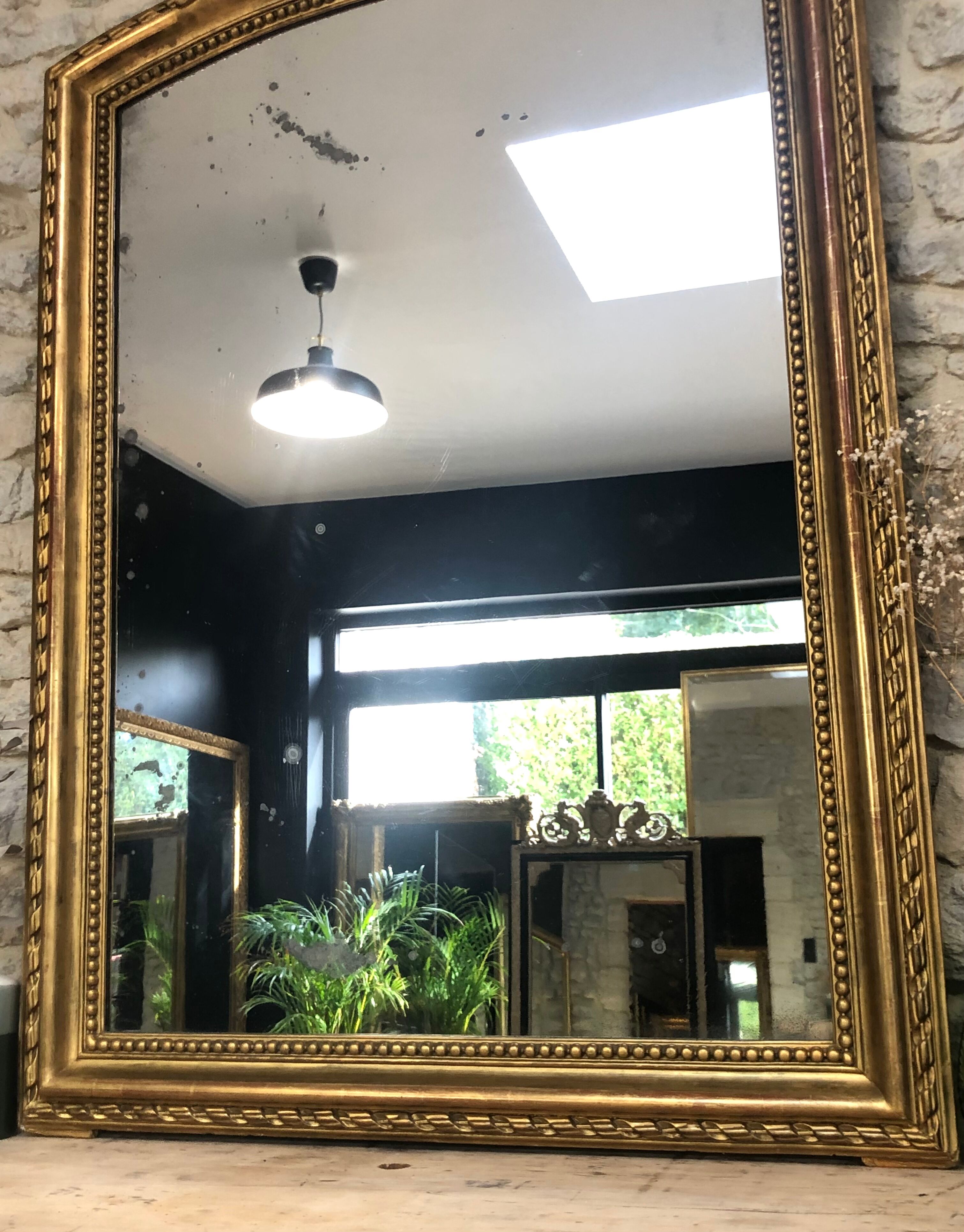 Old mirror 139cm/ 91cm Louis-Philippe with pediment period early 19th, presence of gold leaf.