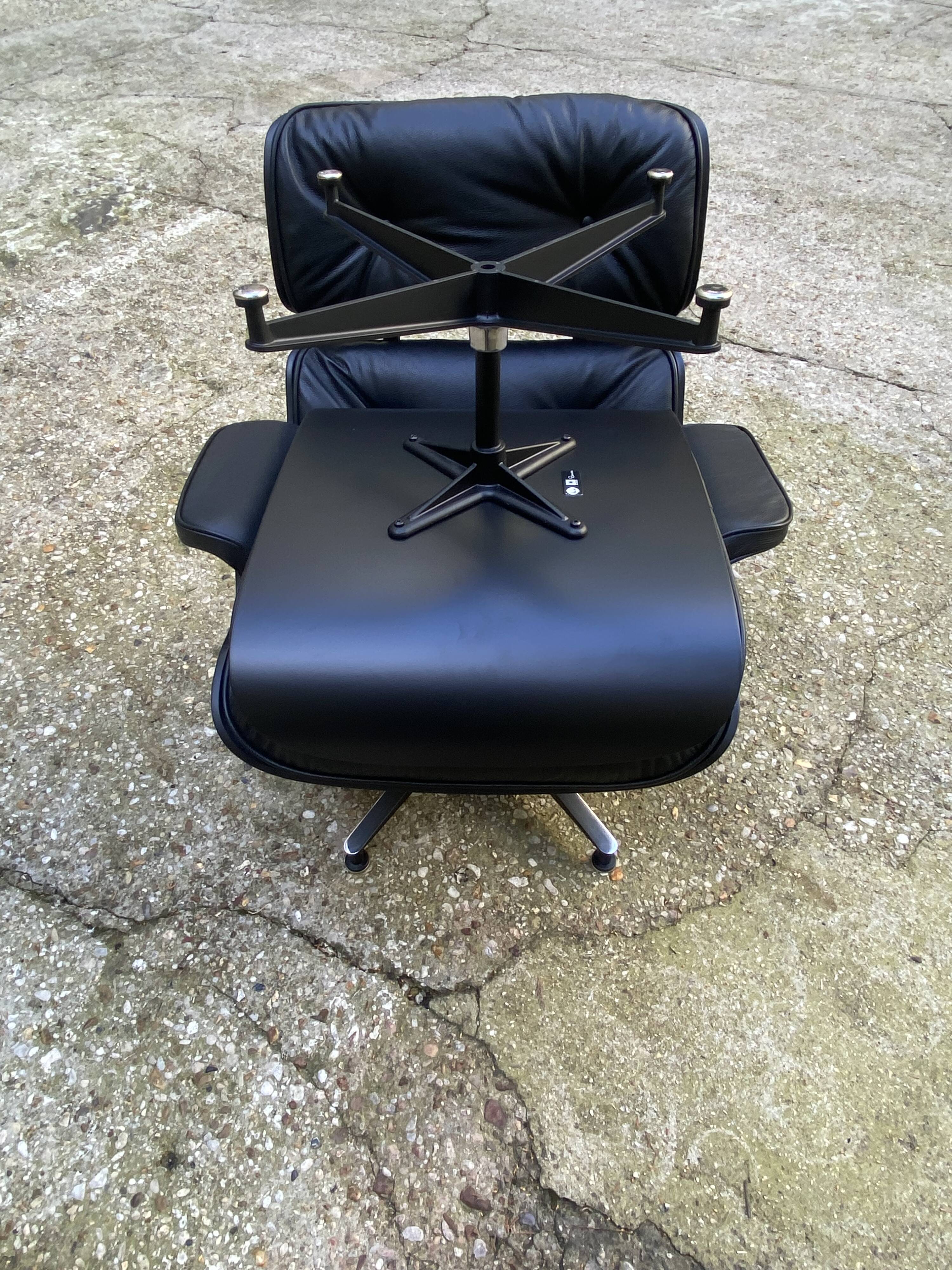 Charles Eames all-black lounge chair and ottoman, Herman Miller edition