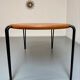 Solid wood dining table with tubular legs, 1980s postmodern design.