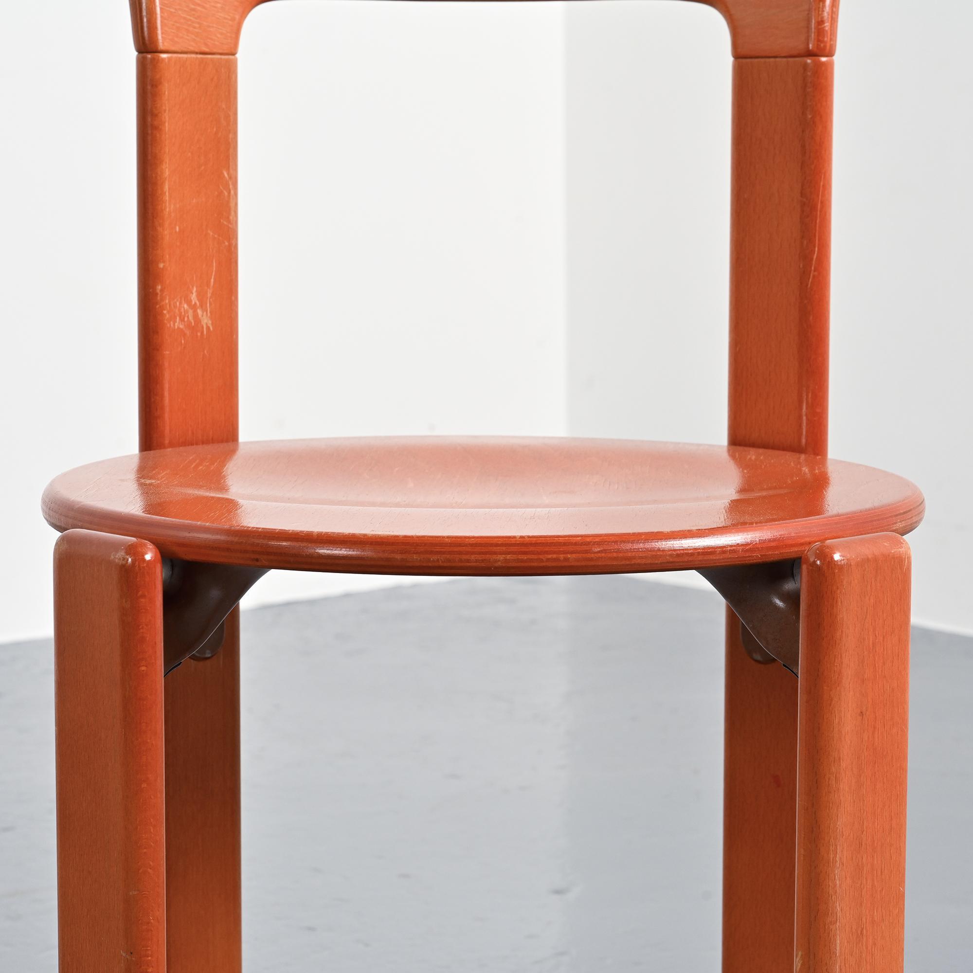 Rey chairs in stained red beech by Bruno Rey
