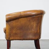 Subtle sheepskin club chair finished with decorative studs