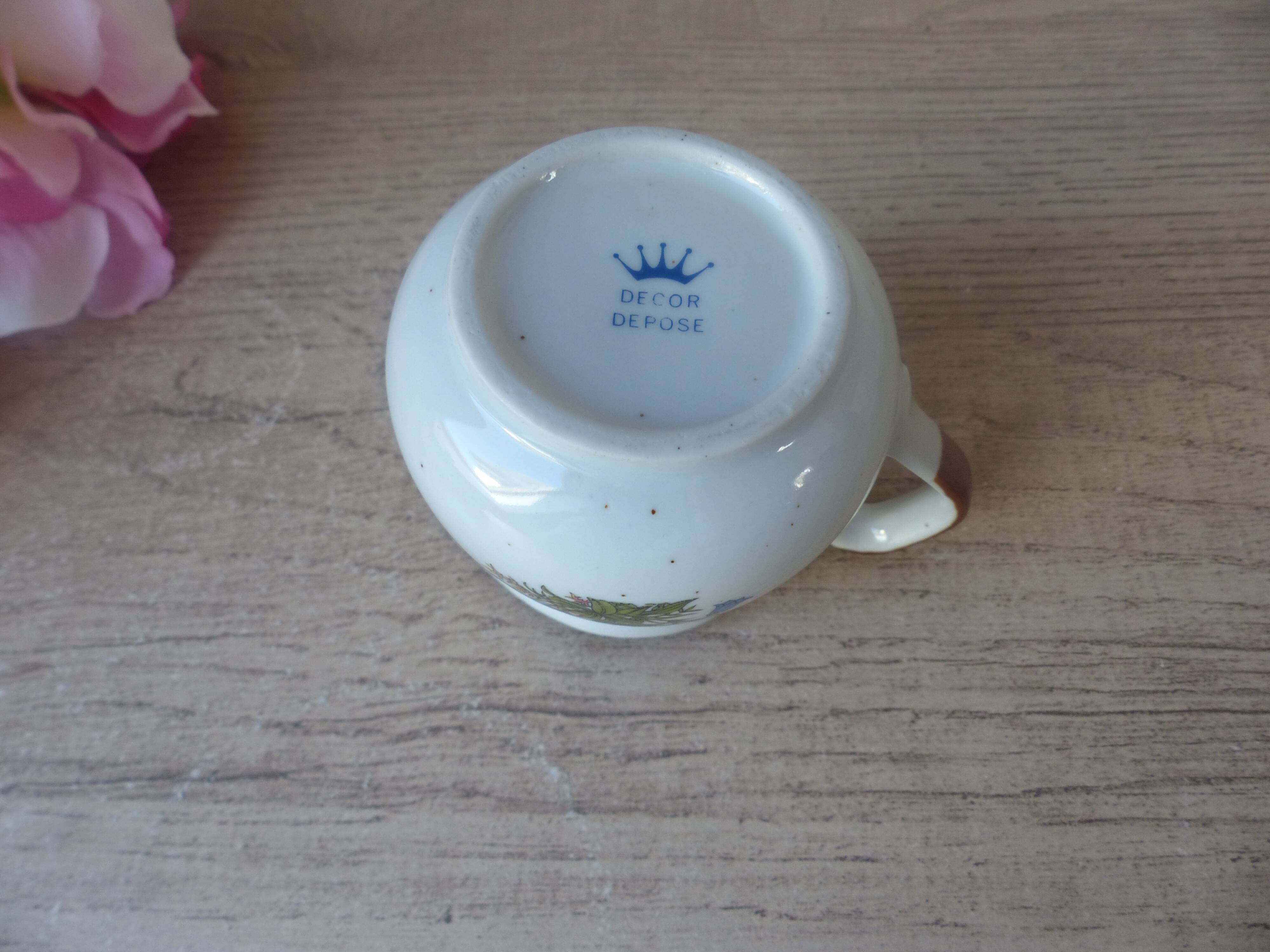 Old small artisanal milk jug in flowered speckled stoneware from the 1980s