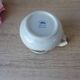 Vintage handmade speckled stoneware milk jug with floral design from the 1980s.