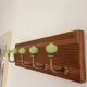 Wall-mounted coat rack with 5 hooks in sage green, stained wood and patinated metal – 50cm