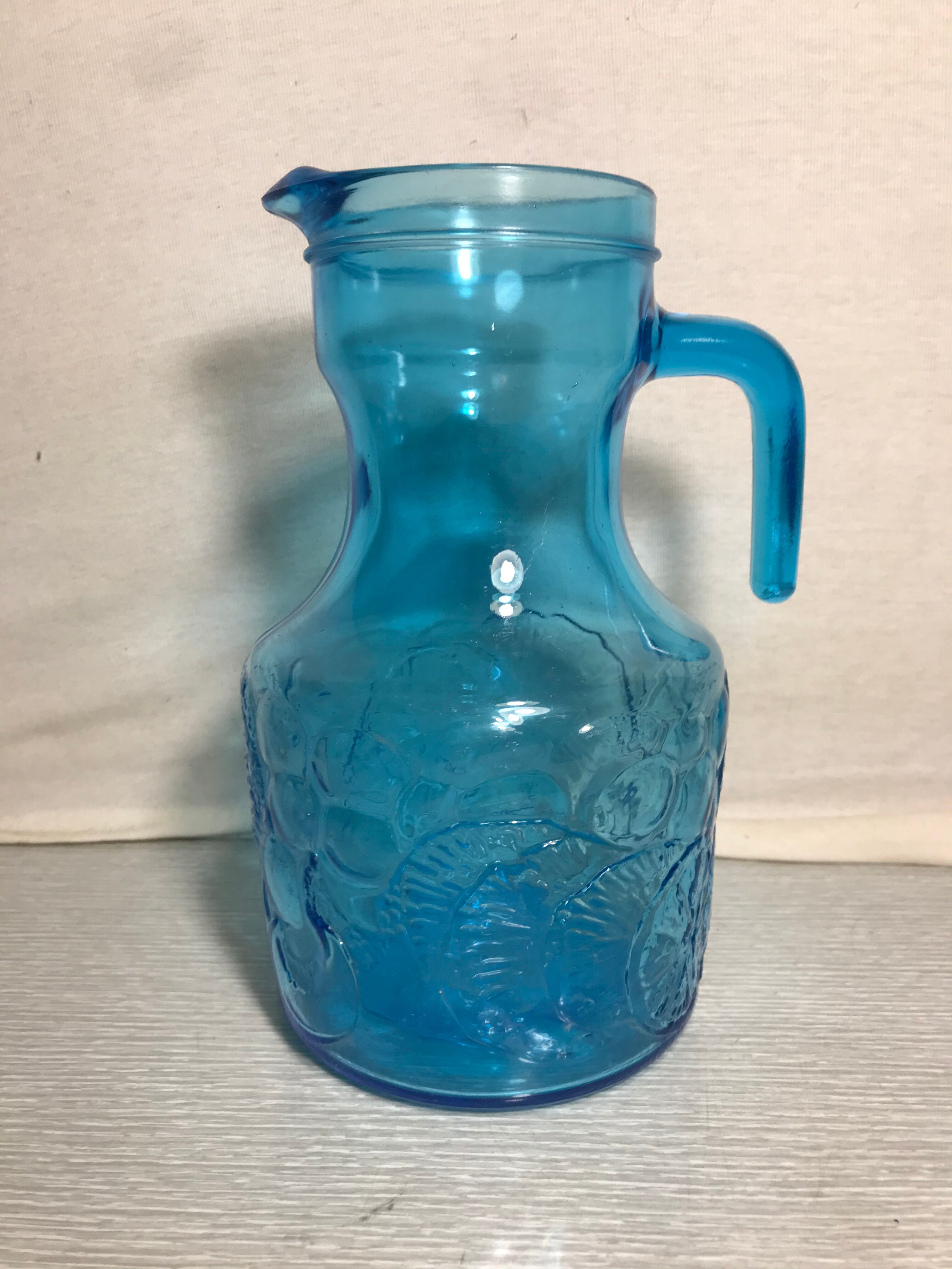 Blue moulded pitcher with decorative handle