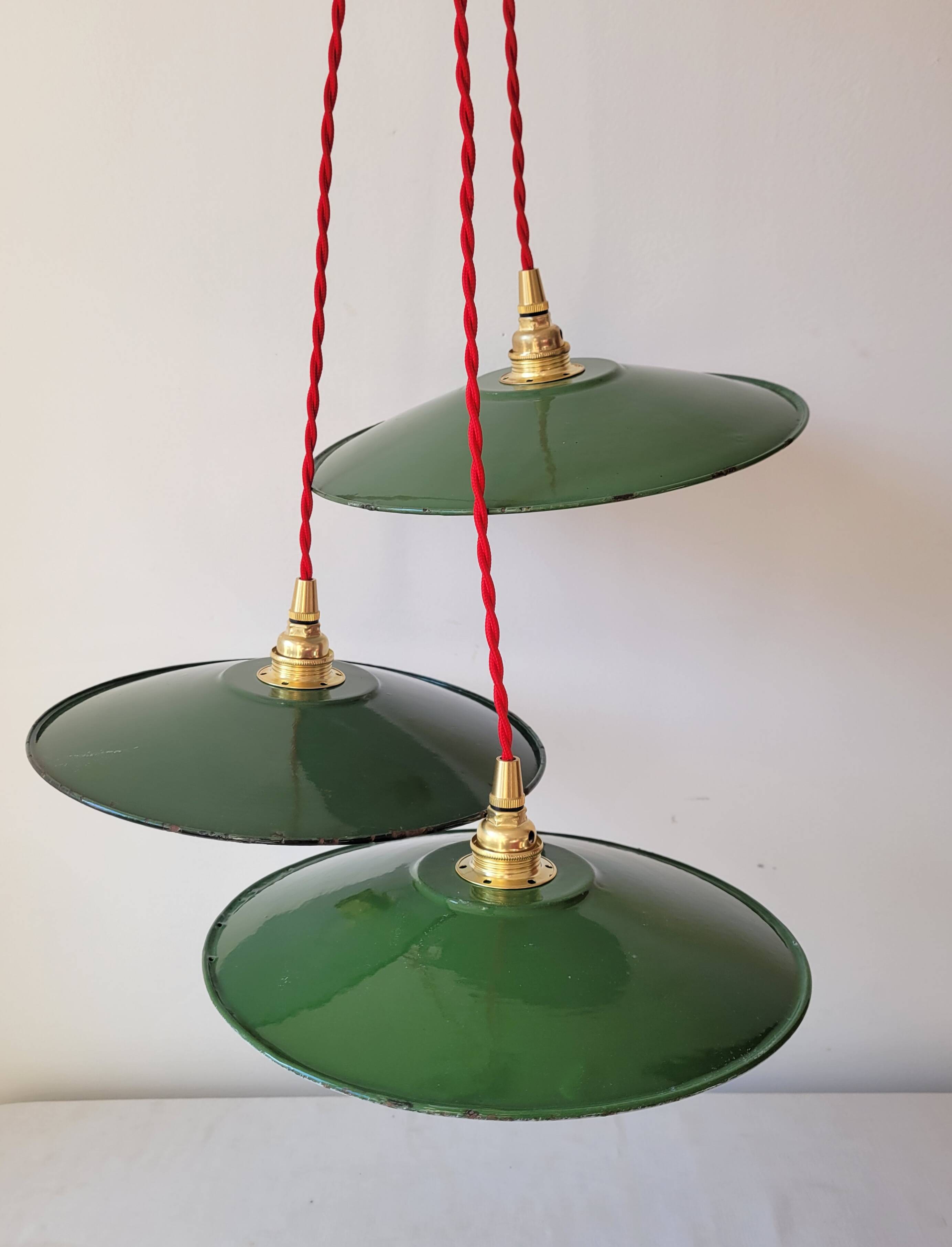 Trio of enameled sheet metal pendant lights