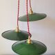 Trio of enameled sheet metal pendant lights