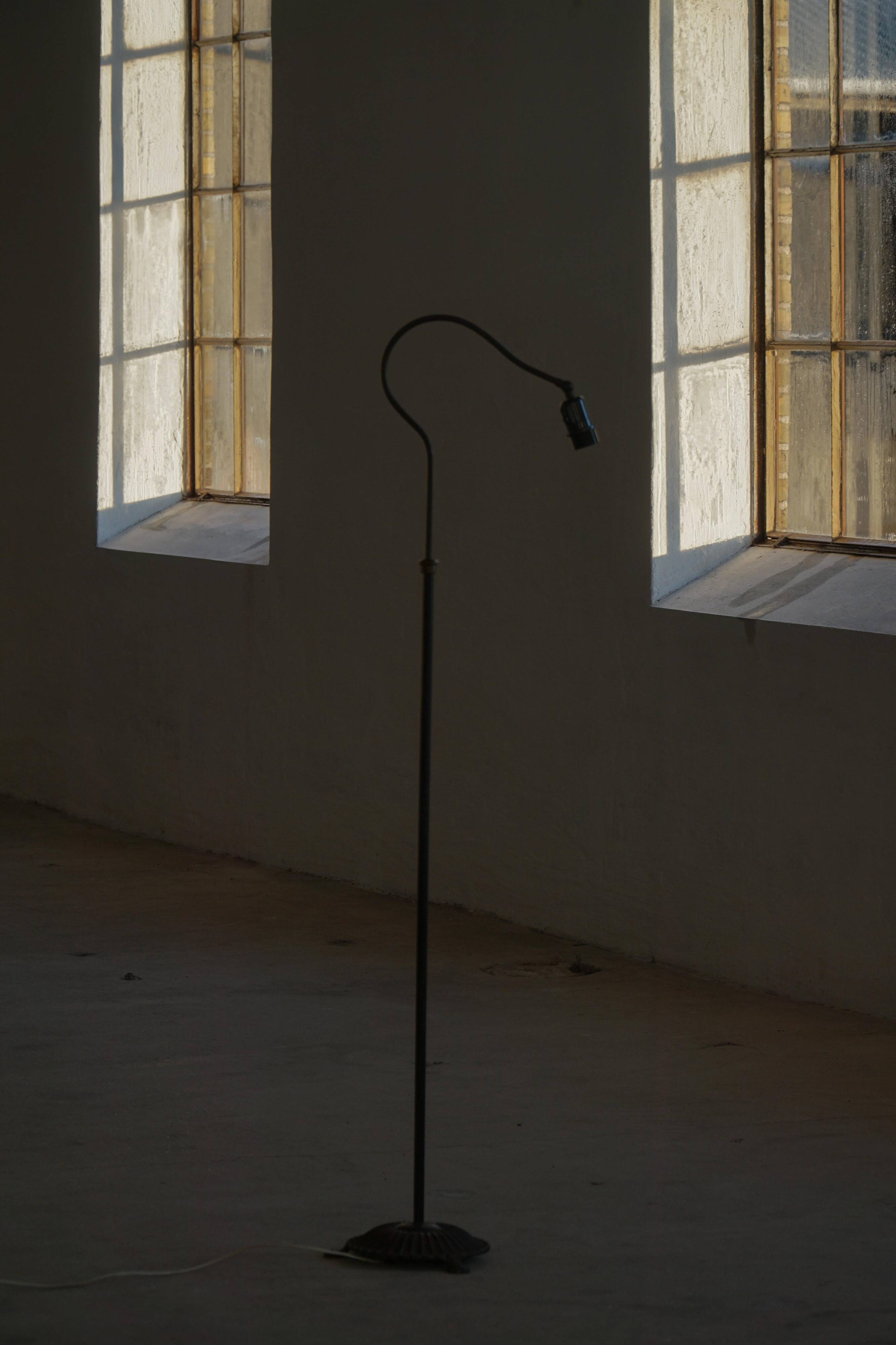 Danish wrought iron floor lamp from the mid-20th century with a curved arm, 1950s.