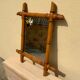 Vintage bamboo mirror in light wood bohemian decoration