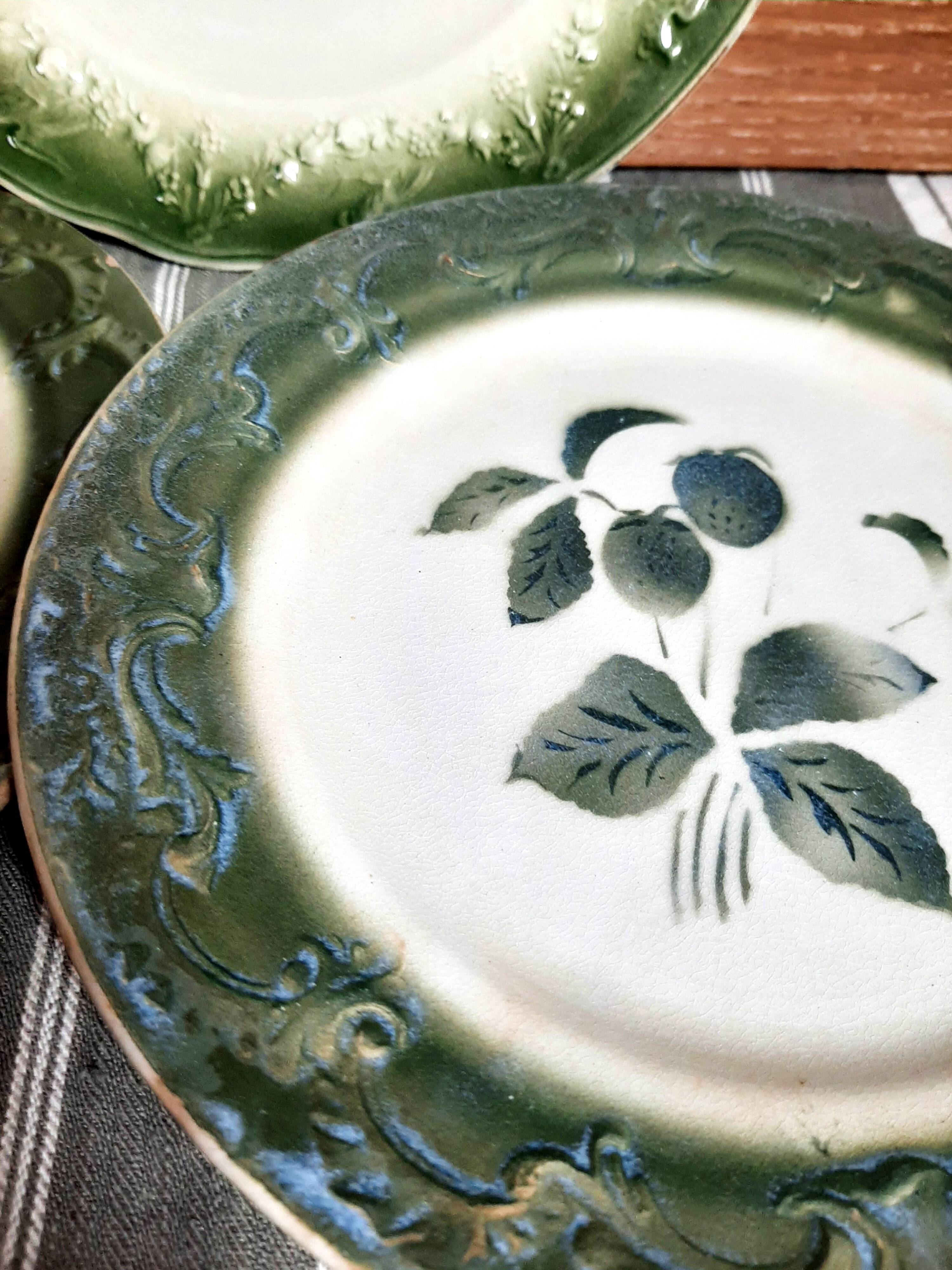 Antique earthenware plates with fruit decoration.