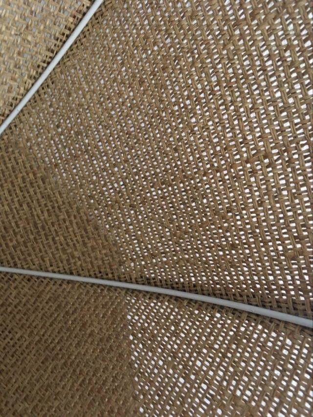 Two-tone flower hanging in braided straw.