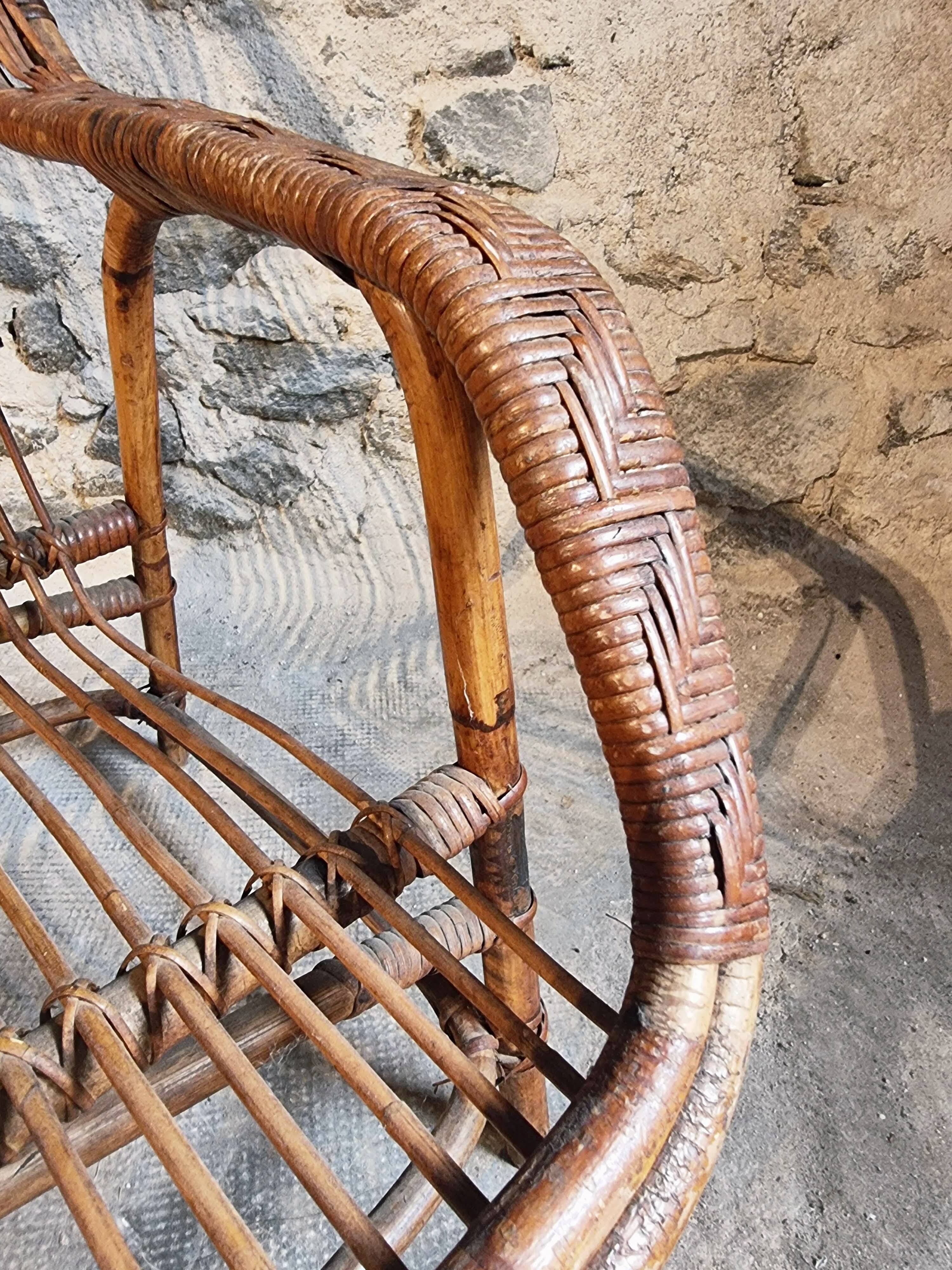 Vintage rattan lounge set, French wicker armchairs and round table, circa 1930–1950.