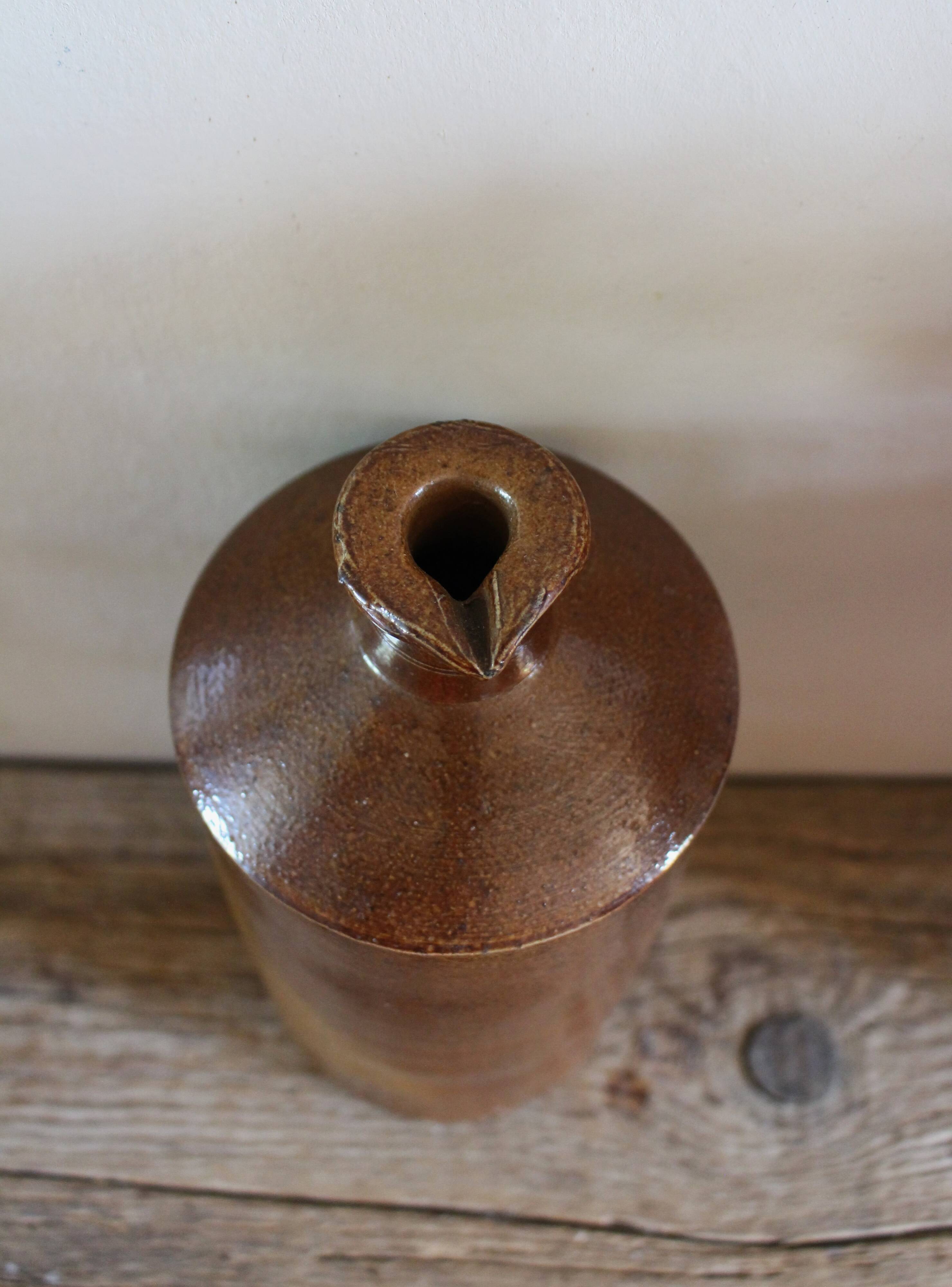 Vintage Bourne Deney stoneware liqueur bottle with pouring spout.