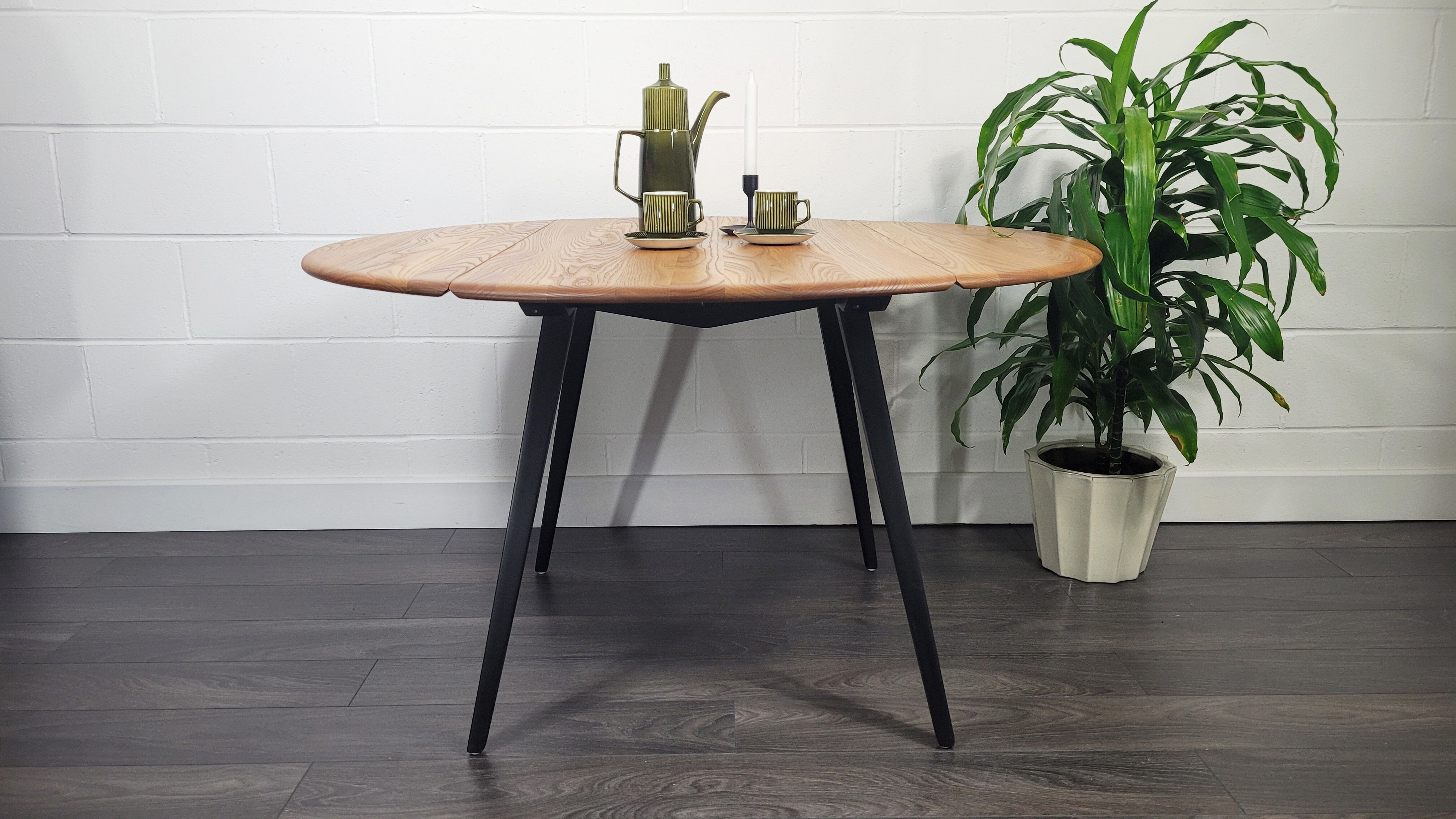 Ercol round drop leaf dining table - black leg, 1960