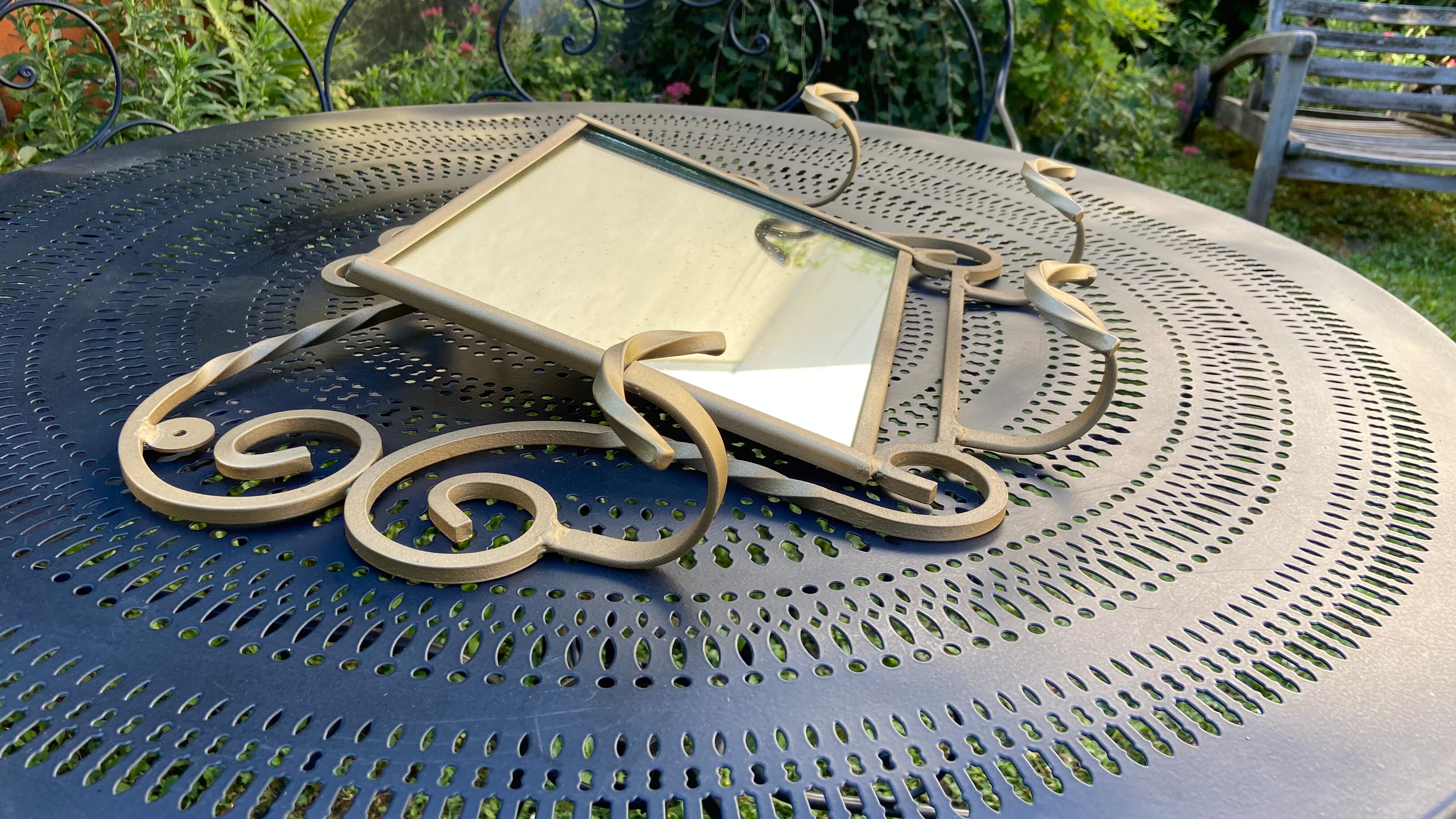 Wall-mounted gilded wrought iron coat rack with mirror