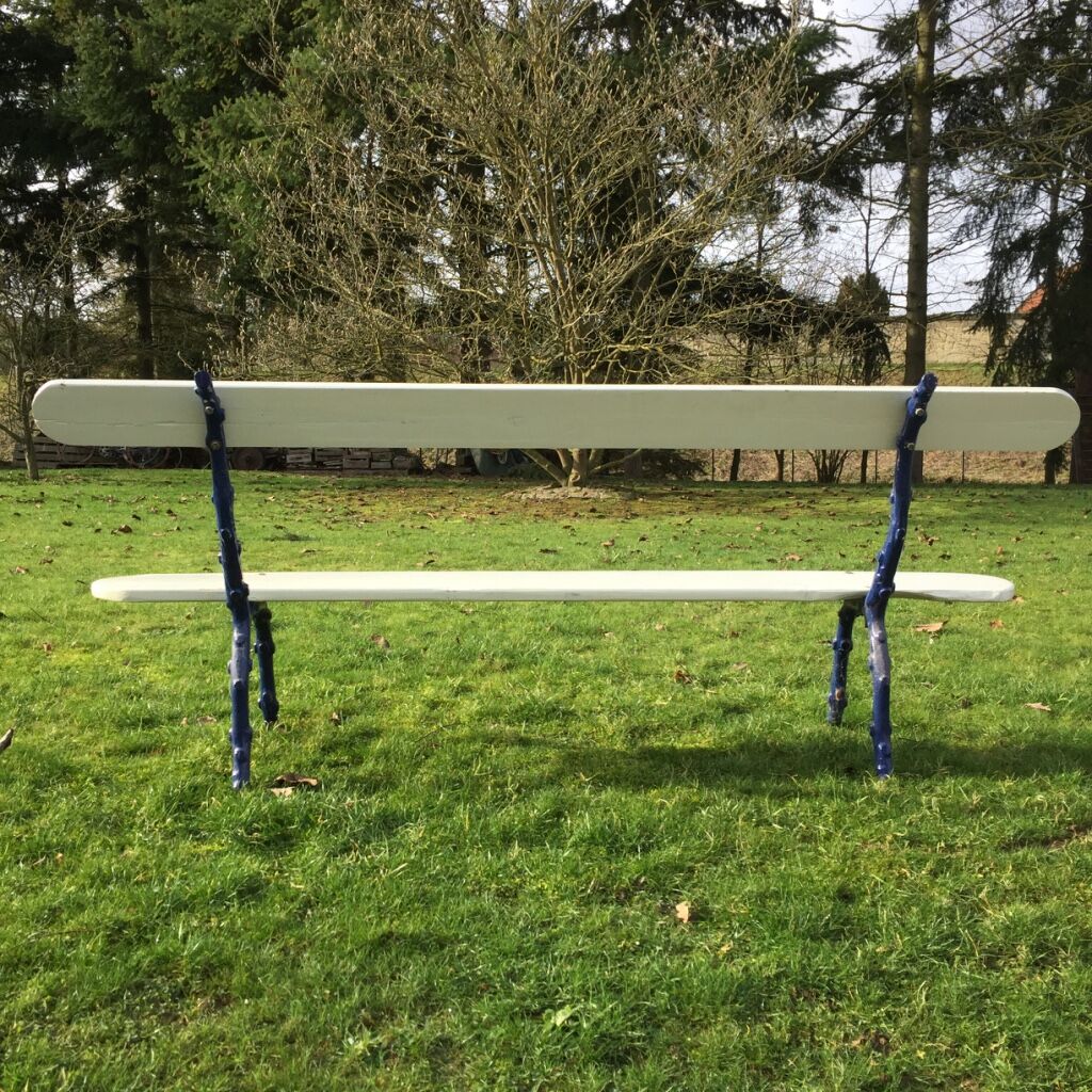 Old wooden garden bench and vine cast iron foot