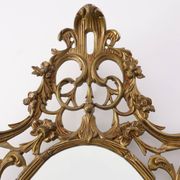 Miroir ovale en métal doré de style rococo, Italie, 20e siècle
