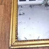 Old mercury mirror in carved wood, gilded with leaf.