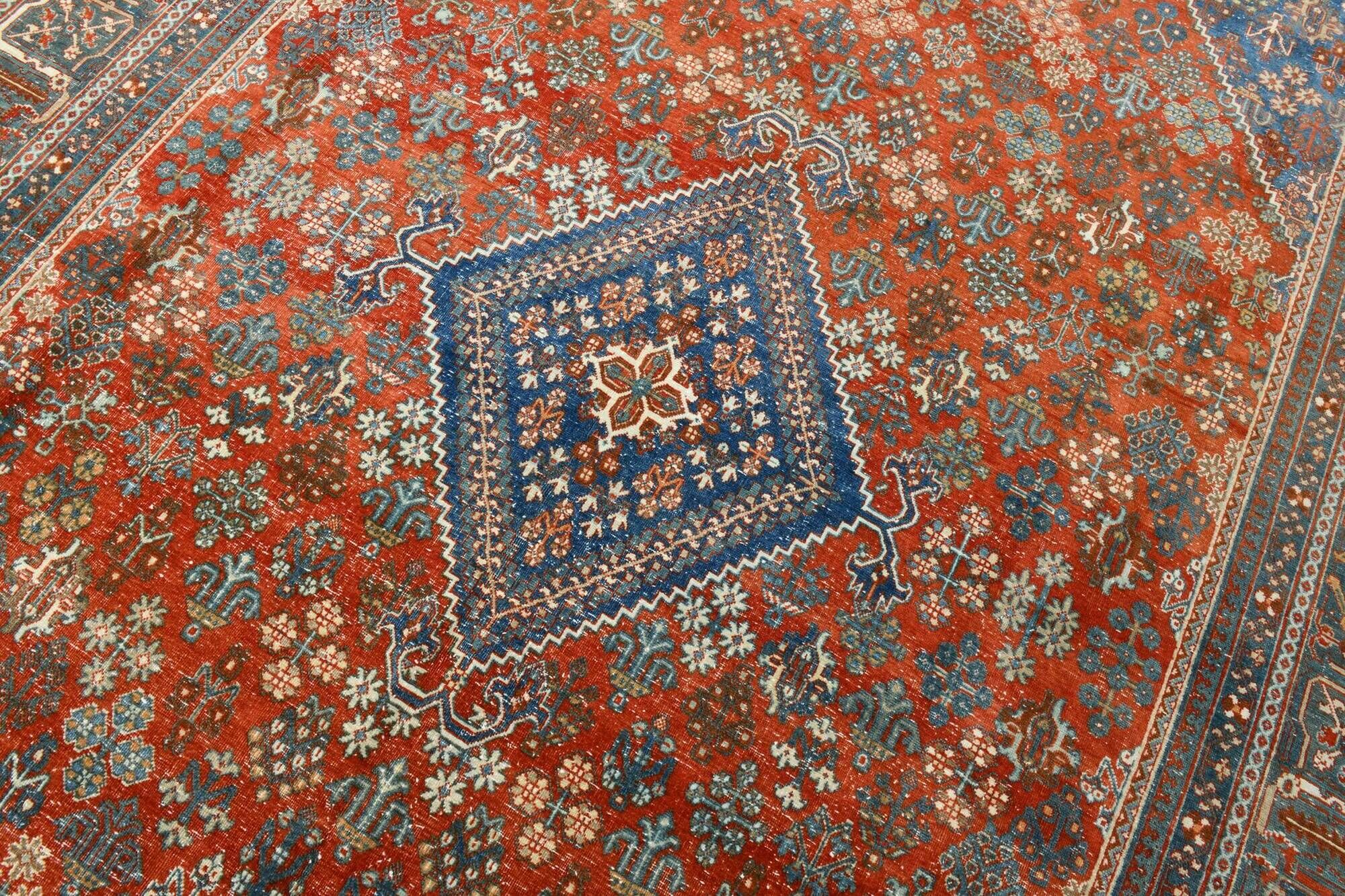Vintage Turkish rug in brick red and indigo with floral design, 276 × 389 cm