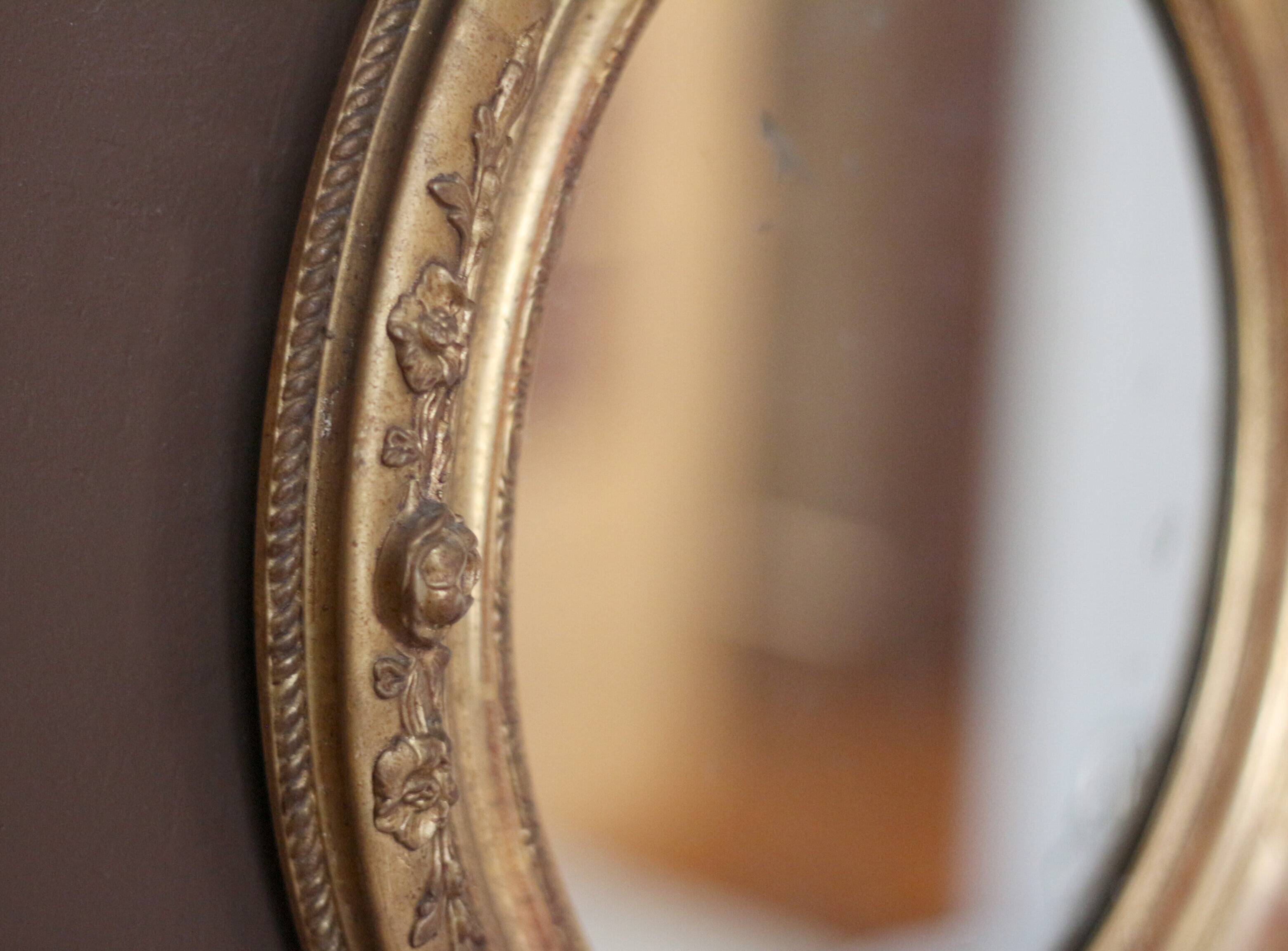 Oval wall mirror with gilded frame and mercury glass. Late 19th-early 20th century.