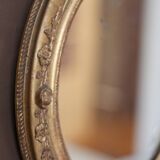 Oval wall mirror with gilded frame and mercury glass. Late 19th-early 20th century.