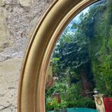 Golden oval mirror
