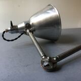 Old industrial lamp has vise 'mazda '.