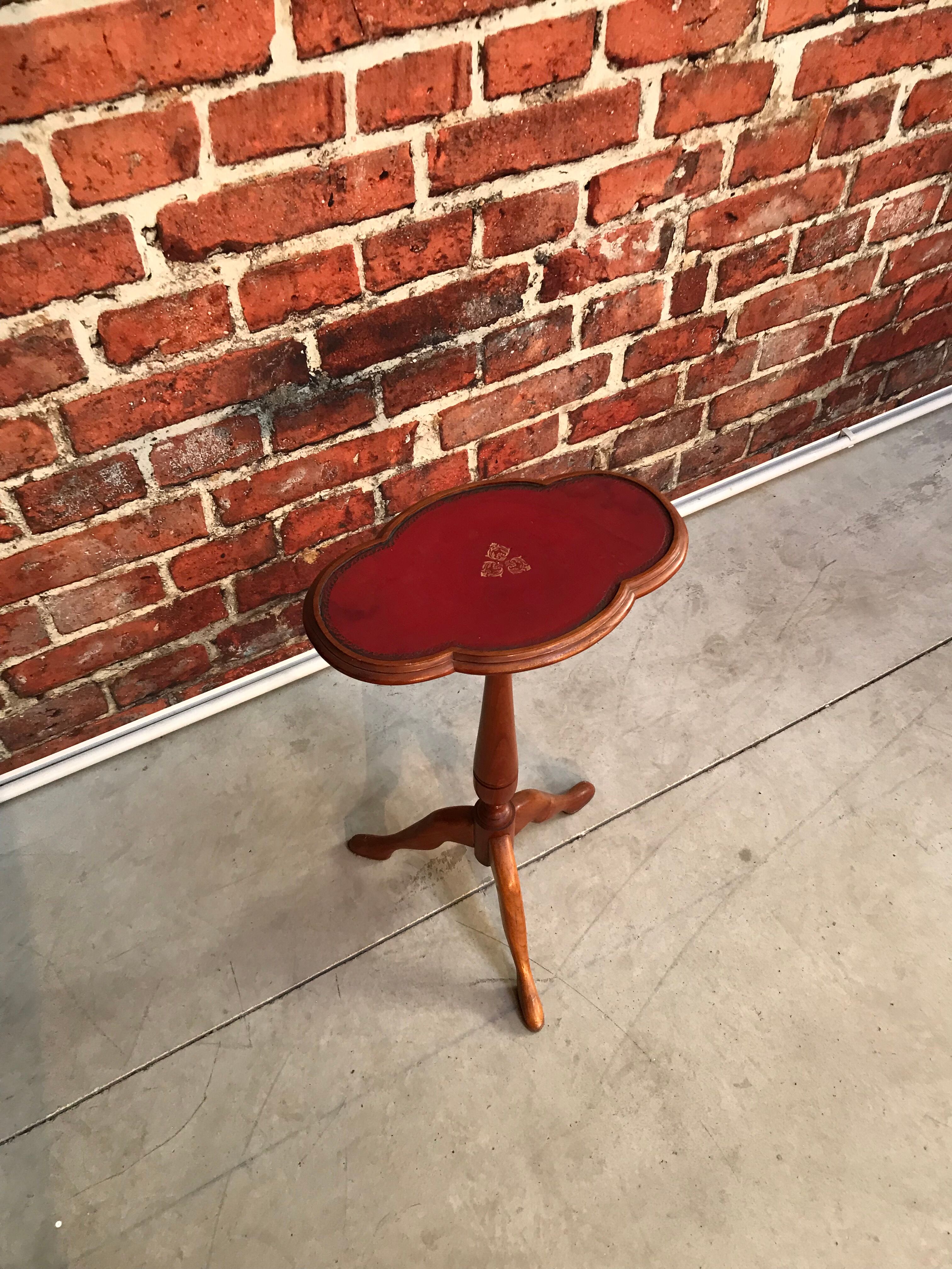 Wooden pedestal table red leather top