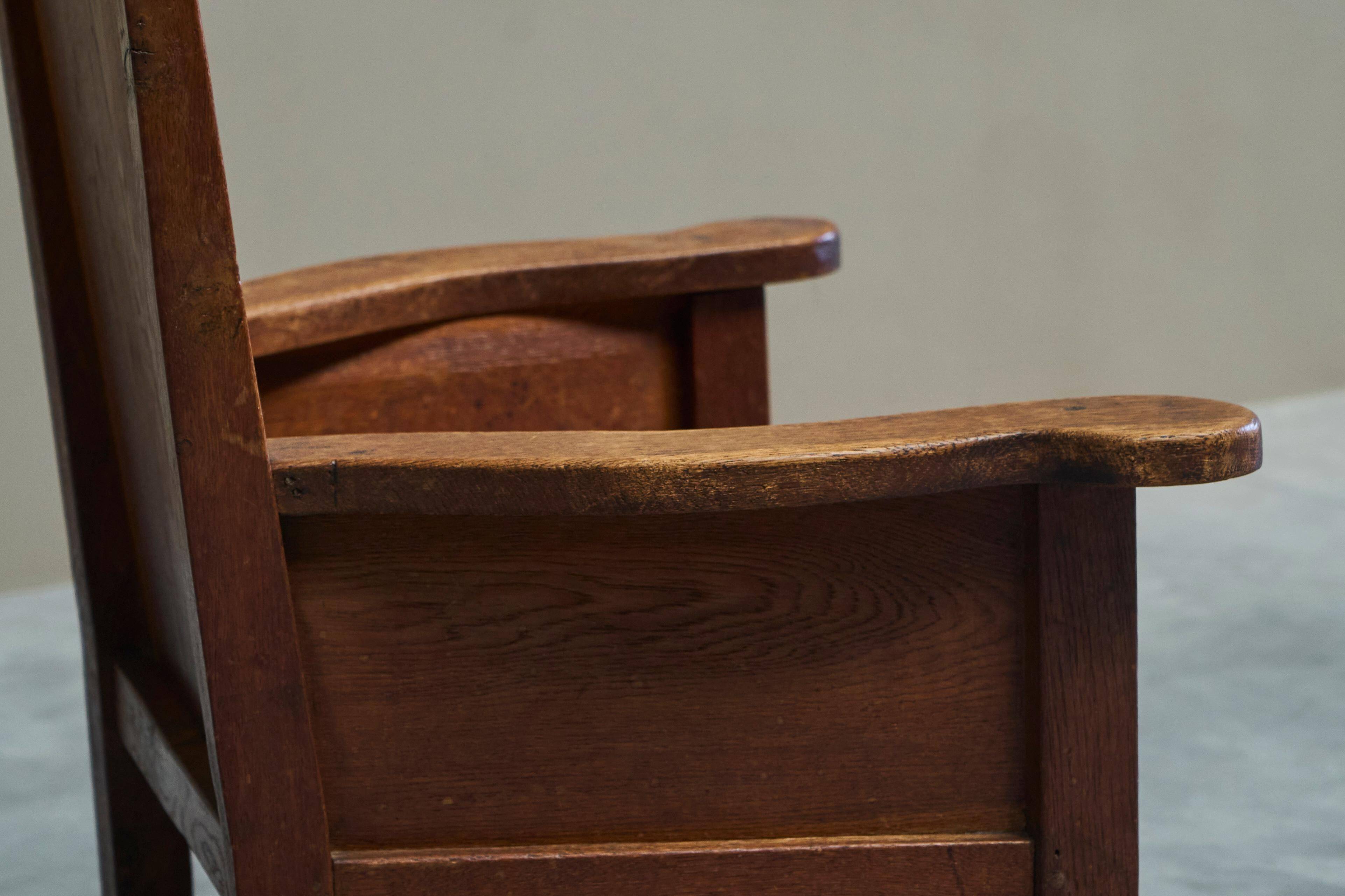Antique solid oak armchair, 19th-century farmer style.