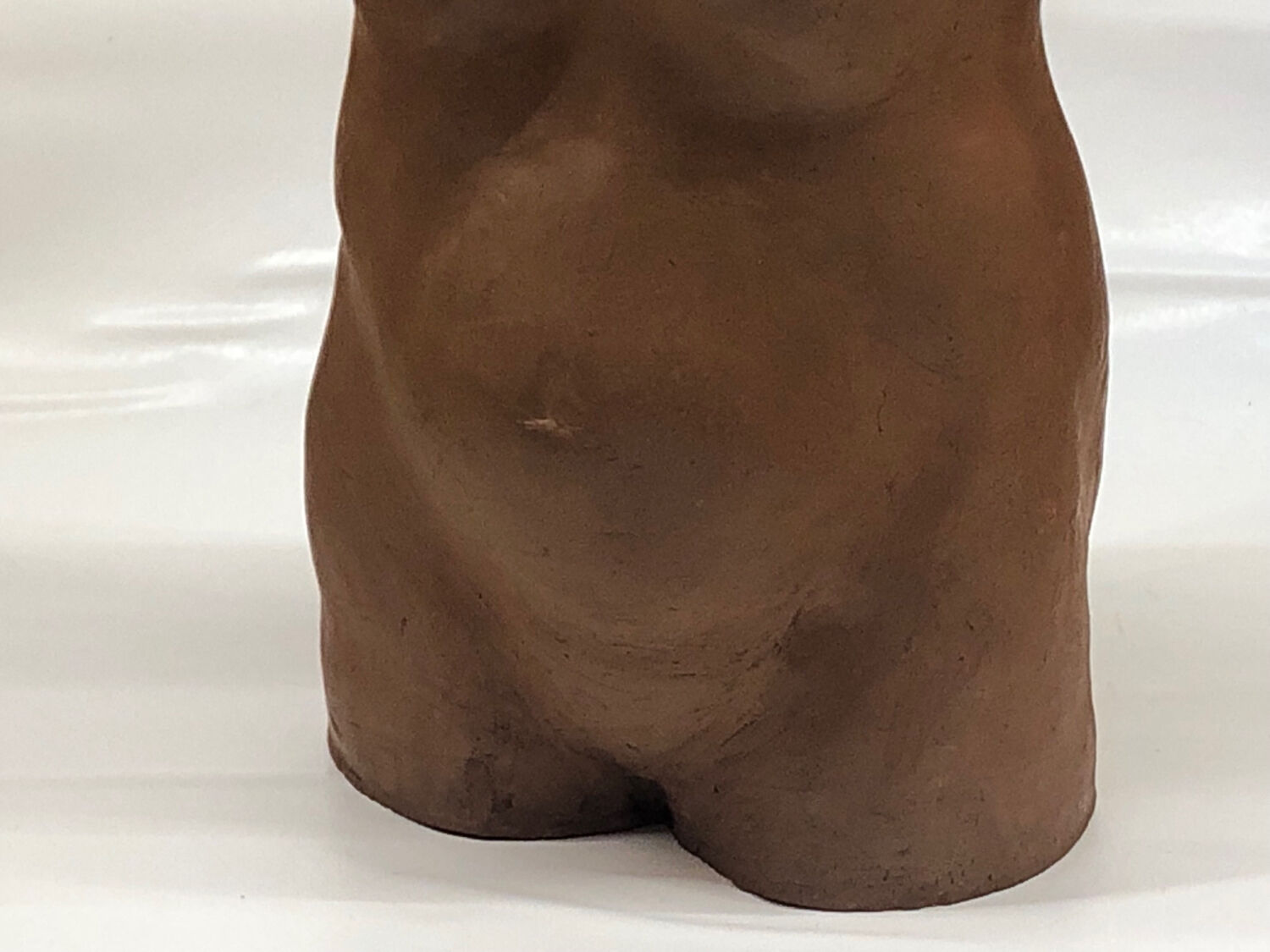 School bust of a female body in red clay terracotta