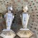 Pair of metal candlesticks, chiseled with a statuette in front, rose pattern in relief, art deco