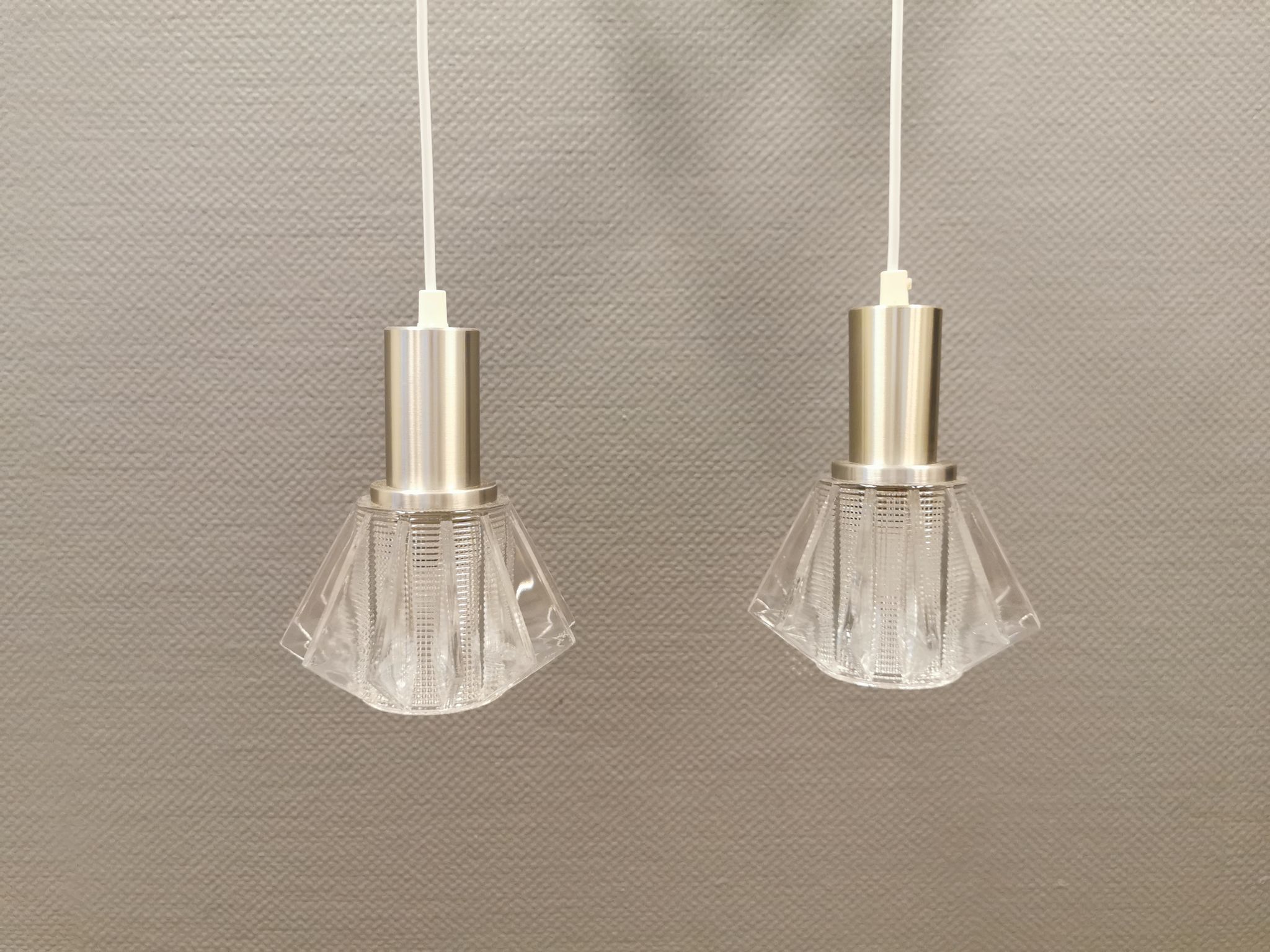 A set of smaller hanging lamps, in hard pressed glass, with metal top