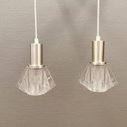 A set of smaller hanging lamps, in hard pressed glass, with metal top