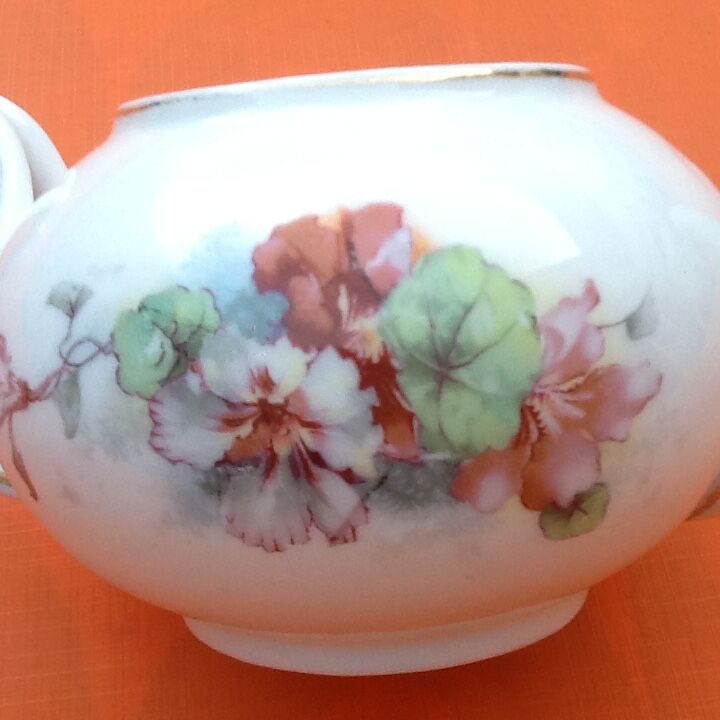 Old porcelain teapot with floral decoration