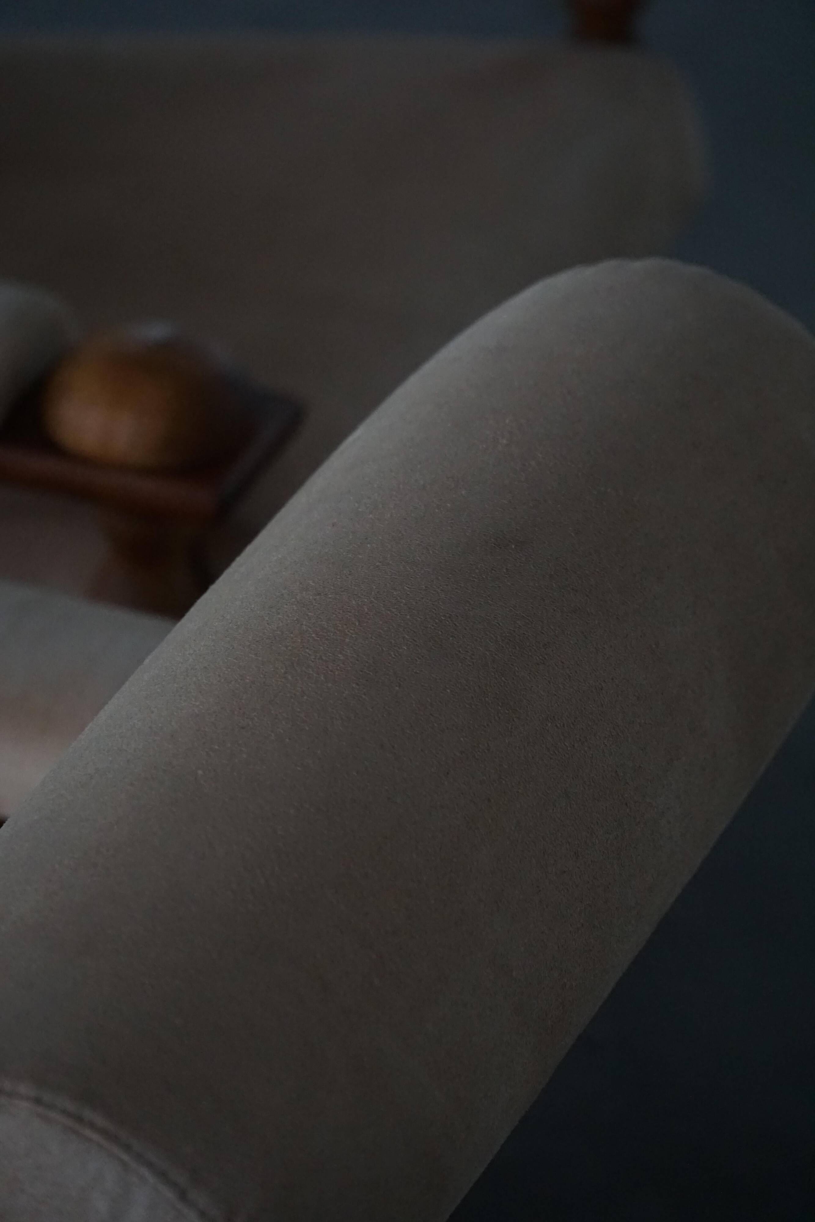 Mid-20th century, pair of armchairs by Henning Kjærnulf, oak and alcantara, 1960s.